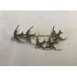 A 925 silver bar brooch in the shape of 5 swooping swallows.