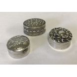 3 small silver decorative pill boxes with engraved detail.