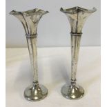 A pair of hallmarked silver posy vases.