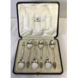 A cased set of Mappin and Webb silver teaspoons with pierced floral decoration to handles.