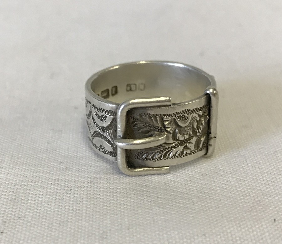 Hallmarked silver buckle ring with ornate decoration.