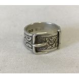 Hallmarked silver buckle ring with ornate decoration.