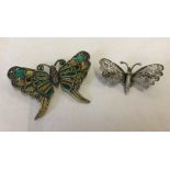 2 butterfly brooches.