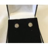 A pair of diamond cluster 9ct gold earrings.