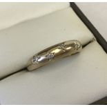Hallmarked 9ct gold band ring set with 5 diamonds.