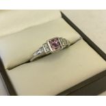 9ct white gold dress ring set with pink sapphires and diamonds.