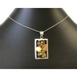 Silver rectangular pendant set with Baltic amber.