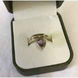 A 9ct gold ring set with teardrop amethyst.