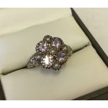 Very pretty vintage silver ring set with 4 amethysts and 5 seed pearls.