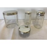 4 silver topped vanity jars.