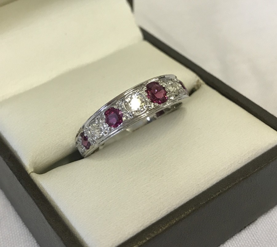 White gold, diamond & ruby ¾ eternity ring.