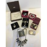 A quantity of boxed costume jewellery items.
