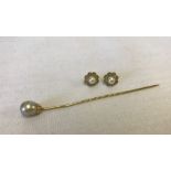 A vintage 18ct gold stick pin set with a faux pearl.