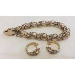 A 9ct gold double link bracelet with heart shaped lock clasp.