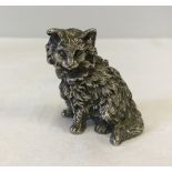 A hallmarked silver salt shaker in the shape of a cat.