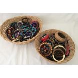 2 wicker baskets containing a large quantity of costume jewellery.