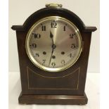 A reproduction wooden cased mantle clock by Bravingtons Ltd, Kings Cross.