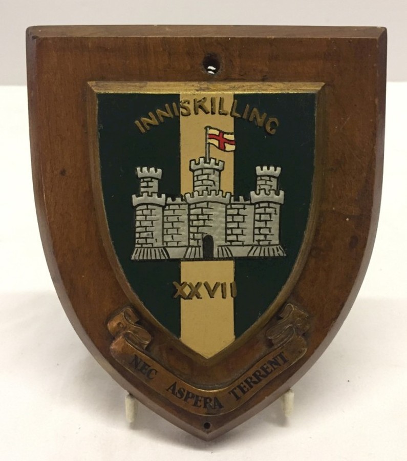 Painted Inniskillings badge on wooden shield 18cm x 15cm.