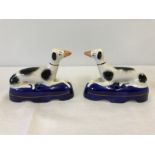 A pair of Staffordshire ceramic greyhounds.