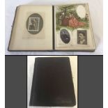 A vintage photo album with coloured plates.