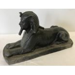 Cast metal figure of an Egyptian Sphynx.