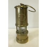 A small brass miner lamp by Lamp and Limelight company of Hockley.
