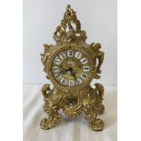 A heavy brass ornamental French style pendulum mantel clock by Johnnie.