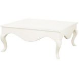 A large white country style wooden square coffee table with cabriole shaped legs.