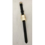 Quartz ladies watch with black leather strap.