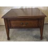 A dark oak coffee table with drawer.