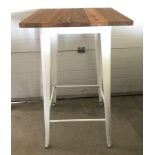 A modern bar style table with pressed steel frame and solid elm wooden top.