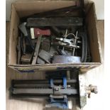 A box of vintage woodworking tools to include planes and clamps.