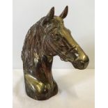 A hollow copper horse head figurine.