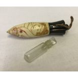 A vintage decorated bone perfume flask with glass inner bottle.