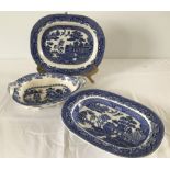 A Masons blue and white willow pattern serving dish with dragon head detail and dragon tail handle.