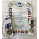 A NATO Meritorious Service medal together with an ISAF Service medal & certificate.