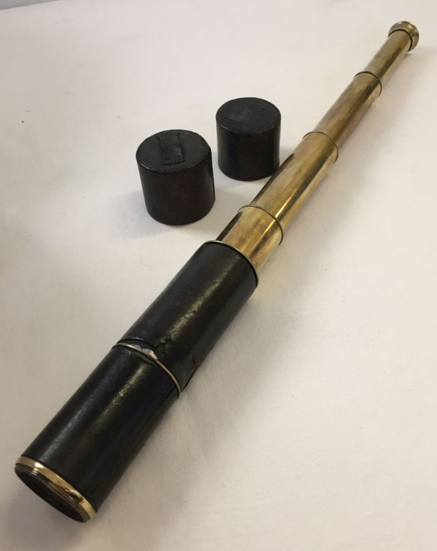 An antique 4 drawer telescope with leather case.