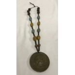 American Red Indian Wars President Johnson Peace medal on beaded rope.