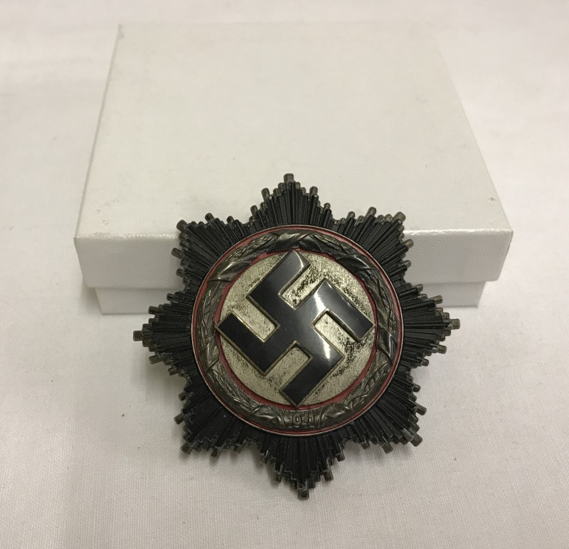 A German WWII Deutches Kreuz , No 1 (denotes Deschler & Sohn) stamped on pin.