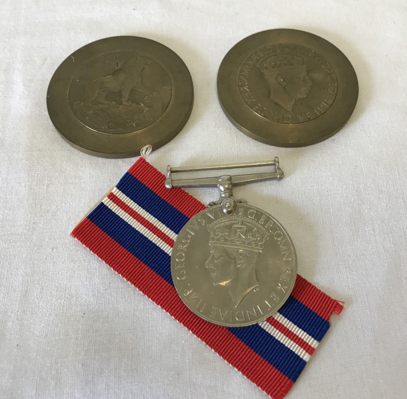 A set of 1939-45 War Medal dies, front and reverse, cancel stamped.