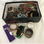 A box of mixed costume jewellery necklaces and bangles