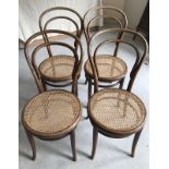 A set of 4 bentwood balloon back chairs with cane seats.