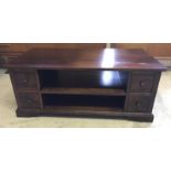 A dark oak double sided coffee table with 8 drawers and central shelf.