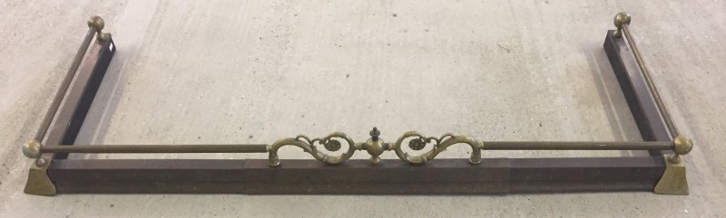 A vintage extending brass fire fender.