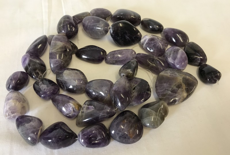 3 strings of large, polished amethyst stones.