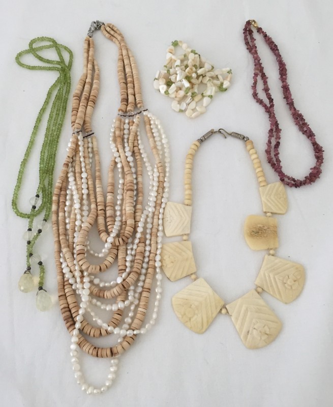 5 necklaces featuring stones, shells and carved bone.