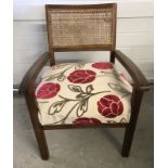 A teak rattan backed nursing chair.