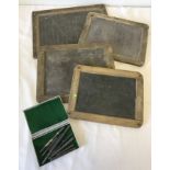 4 Victorian wooden framed school slates together with a box of slate pencils.