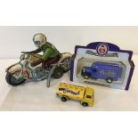 A vintage tinplate wind up motorcycle and rider (winding mechanism needs attention).