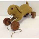 Early Steiff light brown felt rabbit on wheels - remains of Steiff button in left ear.